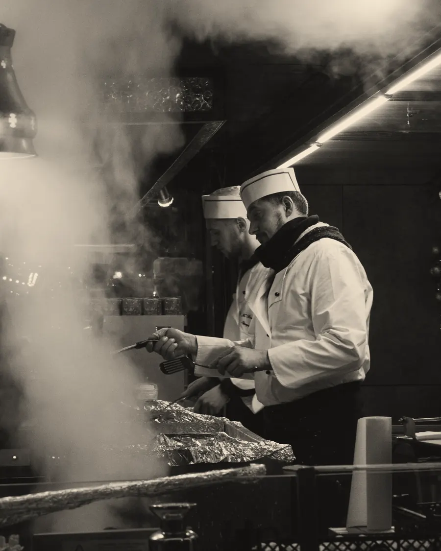 A cook working through smoke in the kitchen