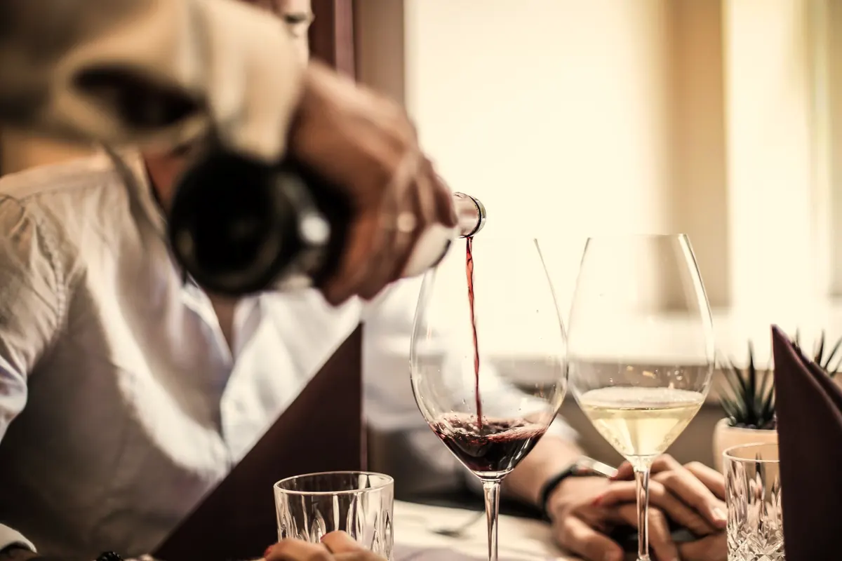 Red wine being poured at the table